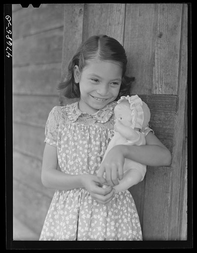 Untitled photo, possibly related to: Guanica, Puerto Rico (vicinity). One of the children of a tenant farmer and her Three Kings' day present