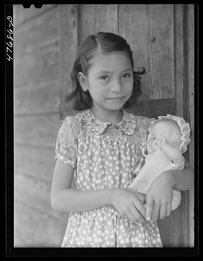 Untitled photo, possibly related to: Guanica, Puerto Rico (vicinity). One of the children of a tenant farmer and her Three Kings' day present