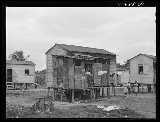 Guayanilla, Puerto Rico. Houses in a company village behind a sugar mill