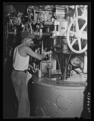 Ensenada, Puerto Rico. Workman operating one of the centrifugals in the South Puerto Rico Sugar Company