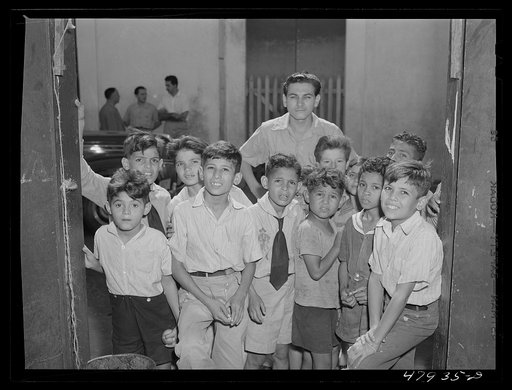 Yauco, Puerto Rico. Children crowding around to watch the photographer