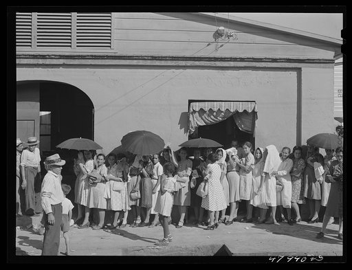 Untitled photo, possibly related to: Cabo Rojo, Puerto Rico. Waiting in line to get surplus commodities. They were distributing fatback and meal