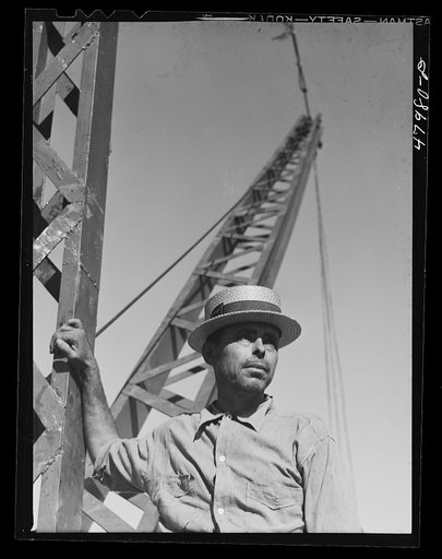 Untitled photo, possibly related to: San Sebastian, Puerto Rico (vicinity). President of a FSA (Farm Security Administration) crane cooperative. There are thirteen members collectively using this crane for loading their sugar cane