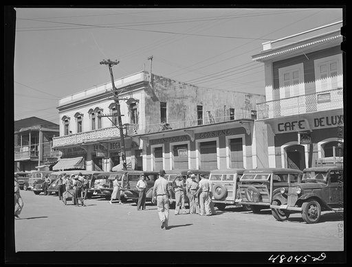 Untitled photo, possibly related to: Arecibo, Puerto Rico. A row of station wagons or "publicos" waiting for loads and passengers