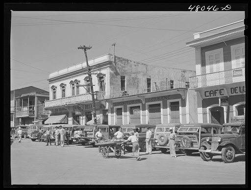 Untitled photo, possibly related to: Arecibo, Puerto Rico. A row of station wagons or "publicos" waiting for loads and passengers