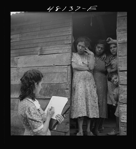 Utuado, Puerto Rico (vicinity). Farm laborer being interviewed by FSA (Farm Security Administration) home management supervisor for eligibility in the FSA labor program