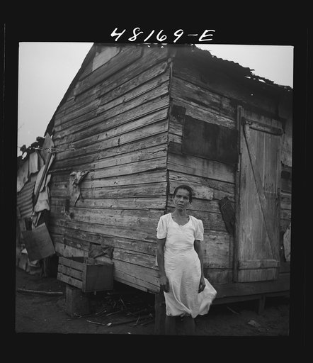 Santurce, Puerto Rico (vicinity). Woman who lives in a house on the land which FSA (Farm Security Administration) is buying for a land and utility housing project