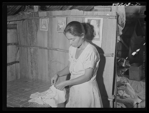 Utuado, Puerto Rico (vicinity). Farm woman doing needlework under contract to a factory in town