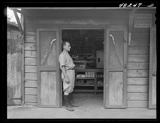 Manati (vicinity), Puerto Rico. At a little general store on a road. On the doors are sample machetes
