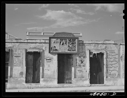 San Sebastian, Puerto Rico. Advertisements for movies on an old building