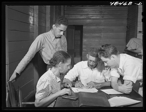 Aibonito (vicinity), Puerto Rico. FSA (Farm Security Administration) borrower and his family signing up for another loan. The county supervisor (right) is looking on