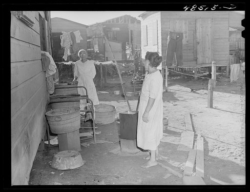 San Juan, Puerto Rico. Washing clothes in a back yard in El Fangitto, a slum area