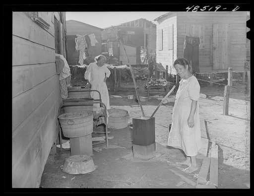 Untitled photo, possibly related to: San Juan, Puerto Rico. Washing clothes in a back yard in El Fangitto, a slum area