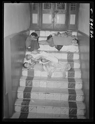 Caguas, Puerto Rico. Homeless people sleeping in the hallway of an apartment house