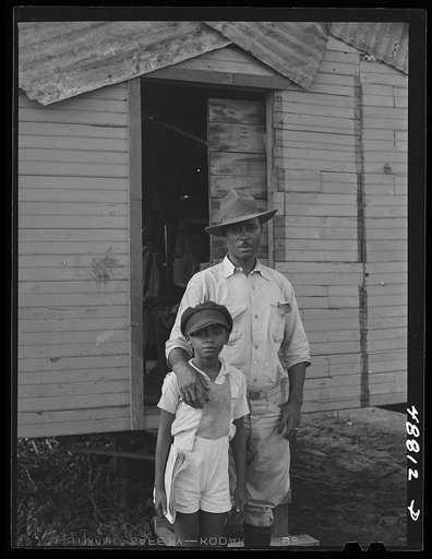 San Juan, Puerto Rico. Worker from the naval base in San Juan who lives in this house in El Fangitto, the slum area