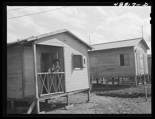 Untitled photo, possibly related to: San Juan, Puerto Rico. Worker from the naval base in San Juan who lives in this house in El Fangitto, the slum area