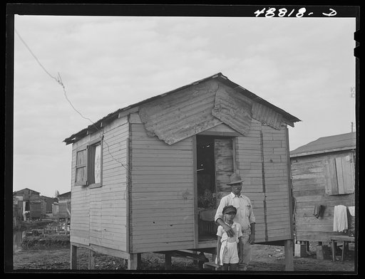Untitled photo, possibly related to: San Juan, Puerto Rico. Worker from the naval base in San Juan who lives in this house in El Fangitto, the slum area