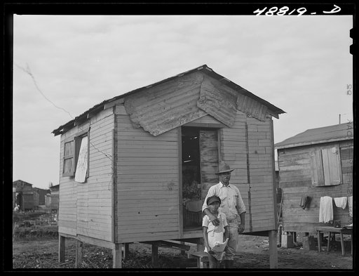 San Juan, Puerto Rico. Worker from the naval base in San Juan who lives in this house in El Fangitto, the slum area