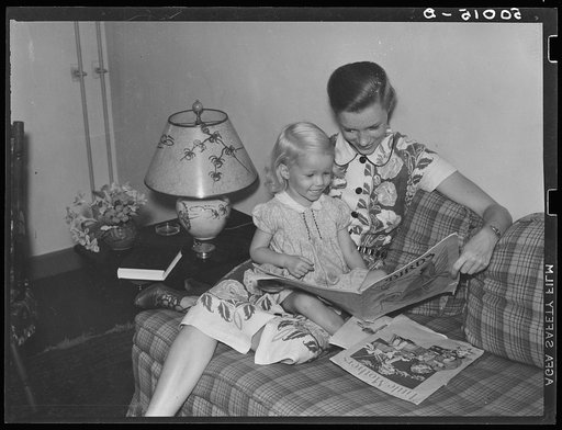 Mrs. Betty Zimmerman and her child in living room of their new home. Greenbelt, Maryland