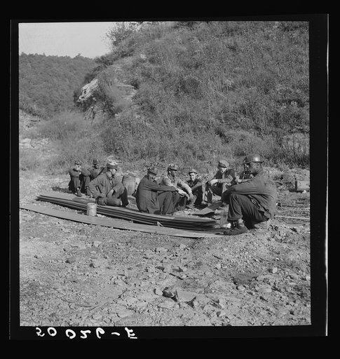 Coal miners waiting for bus to take them home. In Welch, Bluefield section, West Virginia
