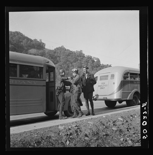 Coal miners waiting along road for bus to take them home. In Welch, Bluefield section, West Virginia