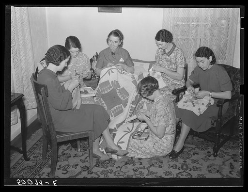 Housewives in Tygart Valley, West Virginia, have weekly group meetings in home economics. Here they are quilting