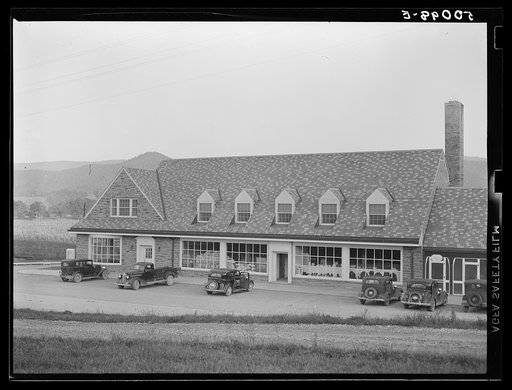 Untitled photo, possibly related to: Roofing materials and flour in window of community store. Tygart Valley project, West Virginia
