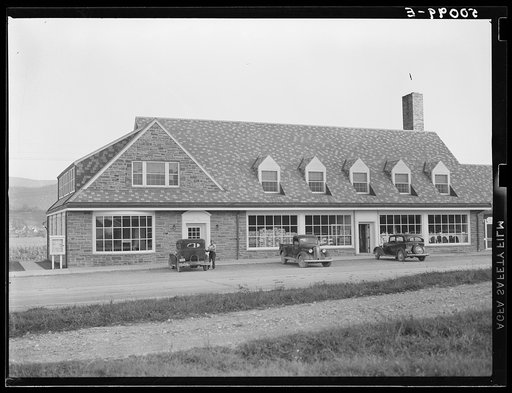 Untitled photo, possibly related to: Roofing materials and flour in window of community store. Tygart Valley project, West Virginia