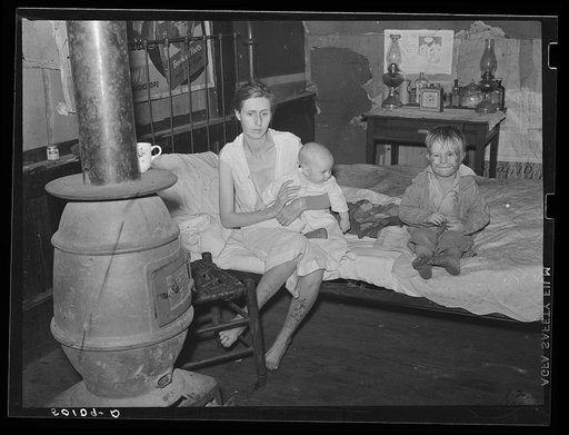 Wife and two children of unemployed mine worker. She has TB and syphilis. They are one of five families living in old abandoned company store in abandoned mining community of Marine, West Virginia