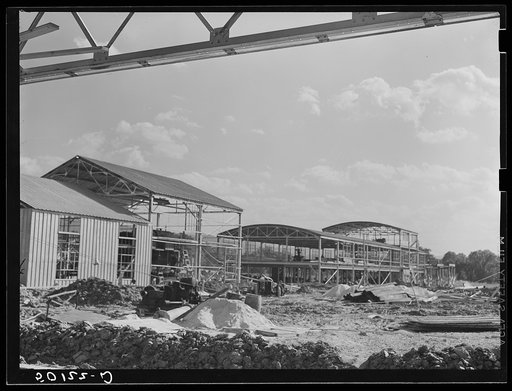 Untitled photo, possibly related to: Construction, new community dimension woodworking factory for making furniture. Showing water tower. Tygart Valley, West Virginia