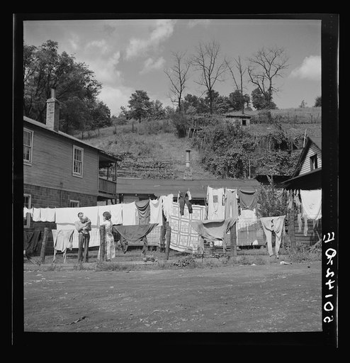 Clothesline on fence and in front yard of coal miner's home. Scotts Run, West Virginia