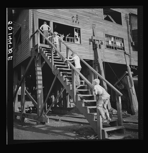 Children playing around old coal tipple. Scotts Run, West Virginia