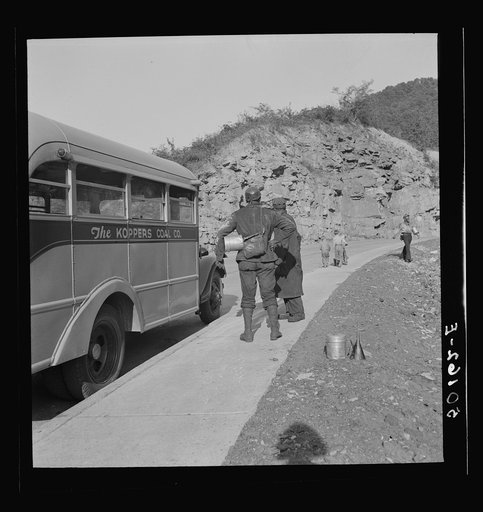 Coal miners waiting along road for bus to take them home. In Welch, Bluefield section, West Virginia