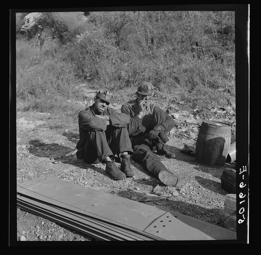 Coal miners waiting along road for bus to take them home. In Welch, Bluefield section, West Virginia