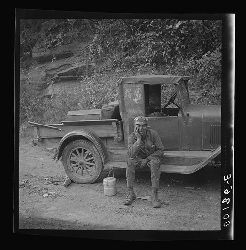 Miner waiting for ride home. Each miner pays twenty-five cents a week to owner of car. Capels, West Virginia