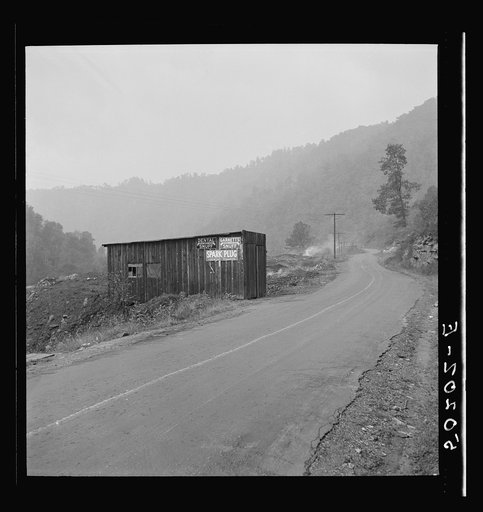 Shack by burning slag heap on main country road near Mohegan, West Virginia