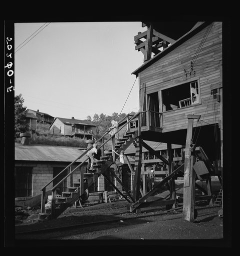 Coal miner's children playing around abandoned tipple. Scotts Run, West Virginia