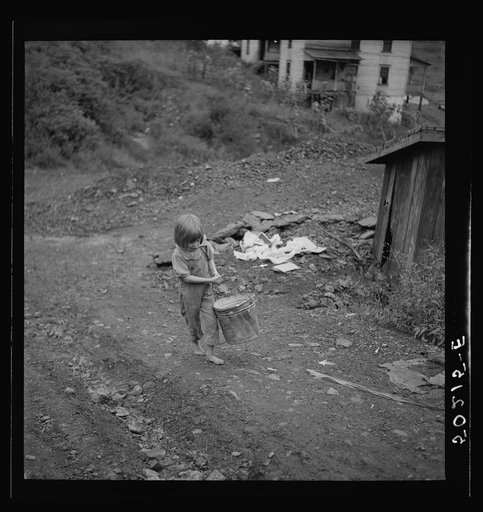 Child of miner carrying home coal she picked out of old slate pile down the hill. Pursglove, Scotts Run, West Virginia