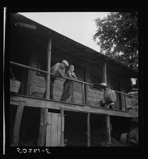 Coal miner and son on porch of their home. The "Patch,"  Cassville, West Virginia