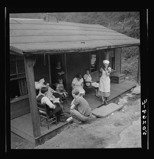Family of man dying of T.B. gather around on front porch. Abandoned mining town, Marine, West Virginia