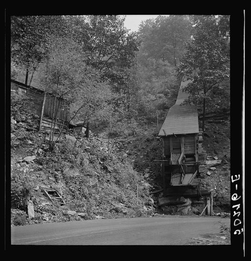 Small, privately owned coal mine next to owner's shacks by the side of the road. Mohegan, West Virginia
