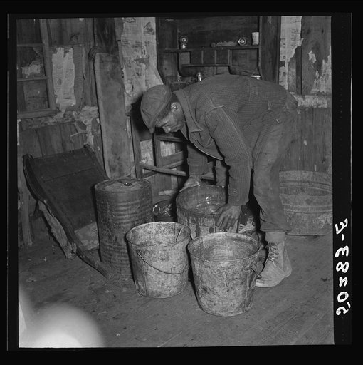 A neighbor (coal miner) taking away some slops for his pigs. Bertha Hill, West Virginia