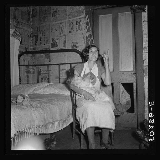 Coal miner's wife and child while discussing conditions of house, lack of steady work for husband. Bertha Hill, West Virginia