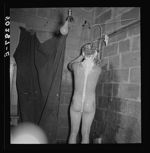 Untitled photo, possibly related to: Miner takes shower, which he built in the cellar of his home. Westover, West Virginia