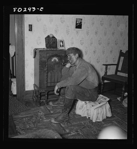 A more well-to-do miner listening to the radio when he returns home in the morning after working on the night shift. He is Polish, his wife Hungarian. These "foreigners" are generally thrifties and their houses are cleaner than the Negros or "Americans." Westover, West Virginia