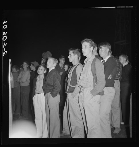 Coal miners' sons watch aerial trapeze artists at outdoor carnival. Large event and only amusement during year. Granville, West Virginia