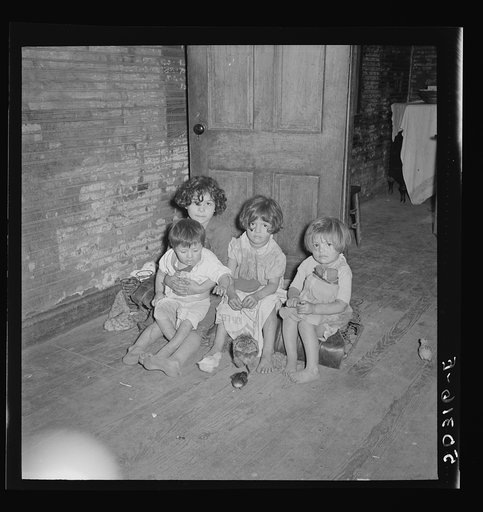 Untitled photo, possibly related to: Mexican miner's children feeding chickens in the kitchen. Their mother is thirty years old and has had ten children. Scotts Run, Bertha Hill, West Virginia
