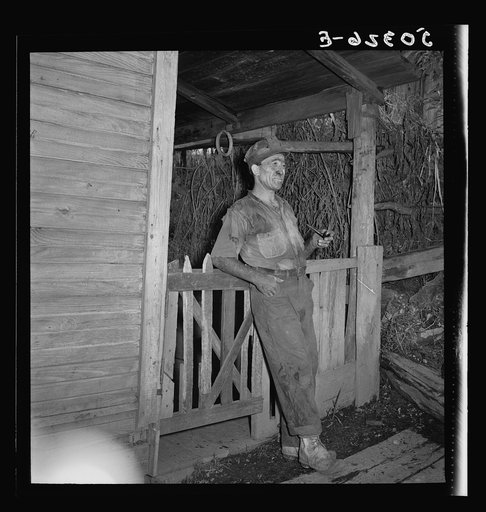 Coal miner (Italian) resting and smoking his pipe after coming home from work. "The Patch," Chaplin, West Virginia