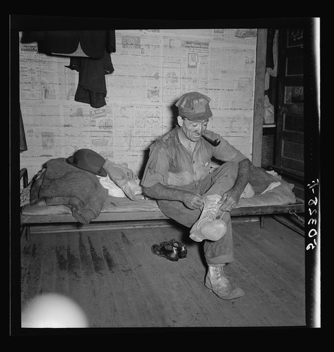 Coal miner (Italian) resting and smoking his pipe after coming home from work. "The Patch," Chaplin, West Virginia