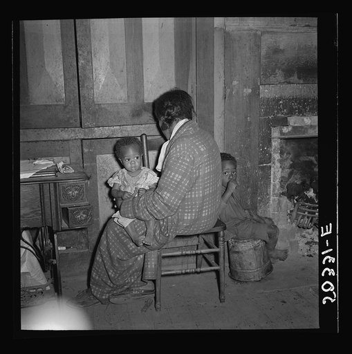 Coal miner's wife, suffering almost constantly with bad bronchial condition, and two of seven children. Chaplin, West Virginia